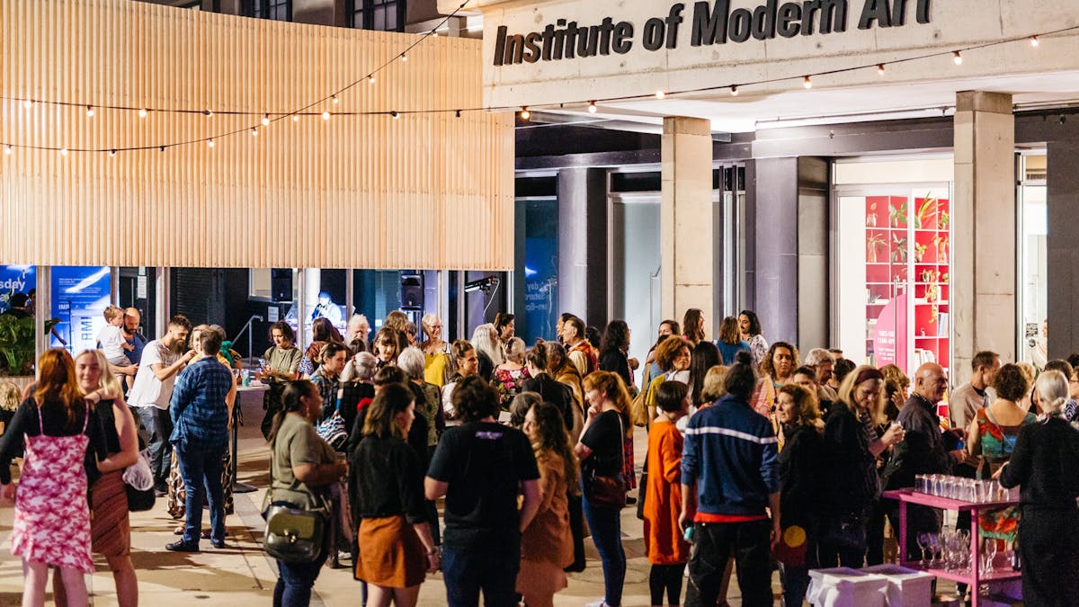 A crowd in a courtyard outside the gallery