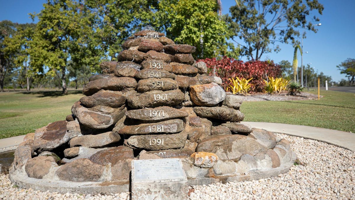 Rocks stacked onto of each other in a well present white rock garden bed.
