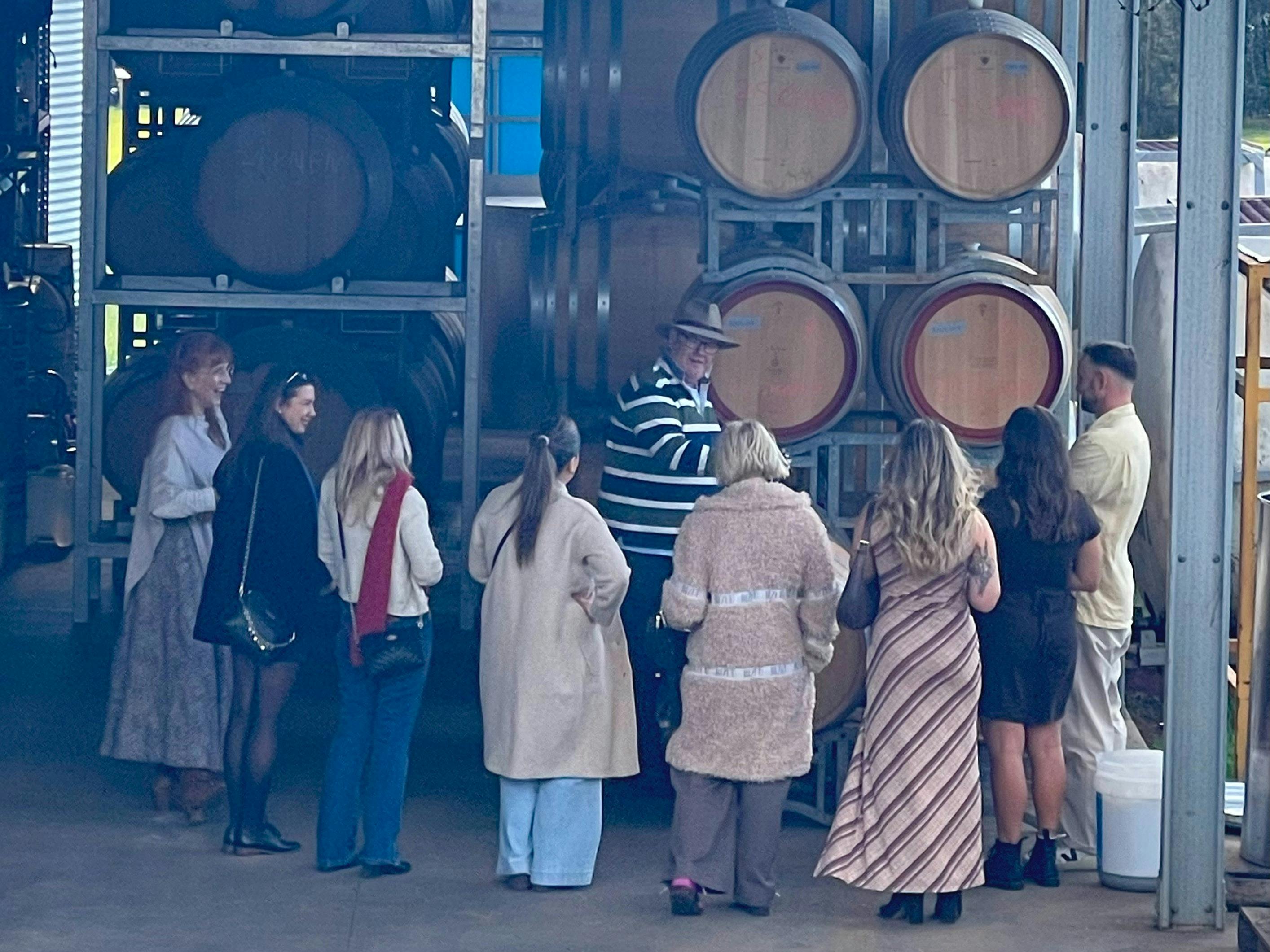 Group of visitors touring the working winery at Hunter Wine Lab in Pokolbin.