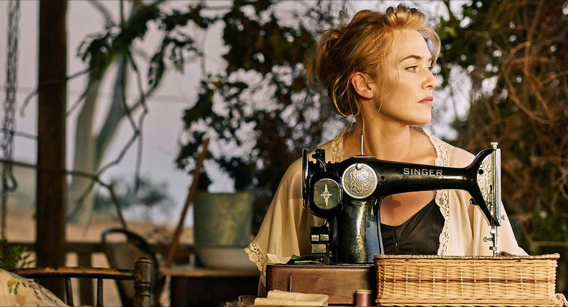 Kate Winslet sits at a Singer sewing machine in a scene from the film, The Dressmaker