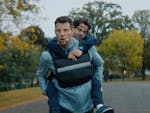 A man runs with another man on his back.