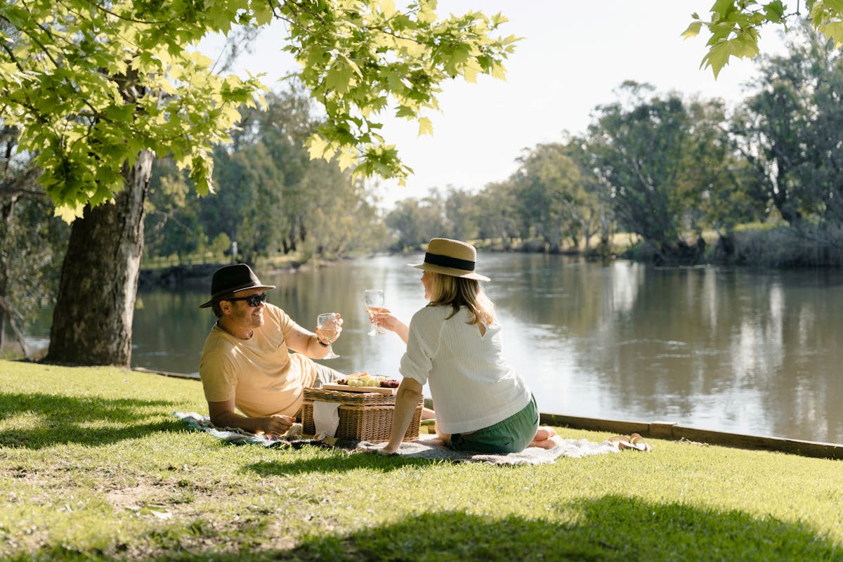 couple pickning under tree along side the Murray River foreshore of Memorial park Howlong