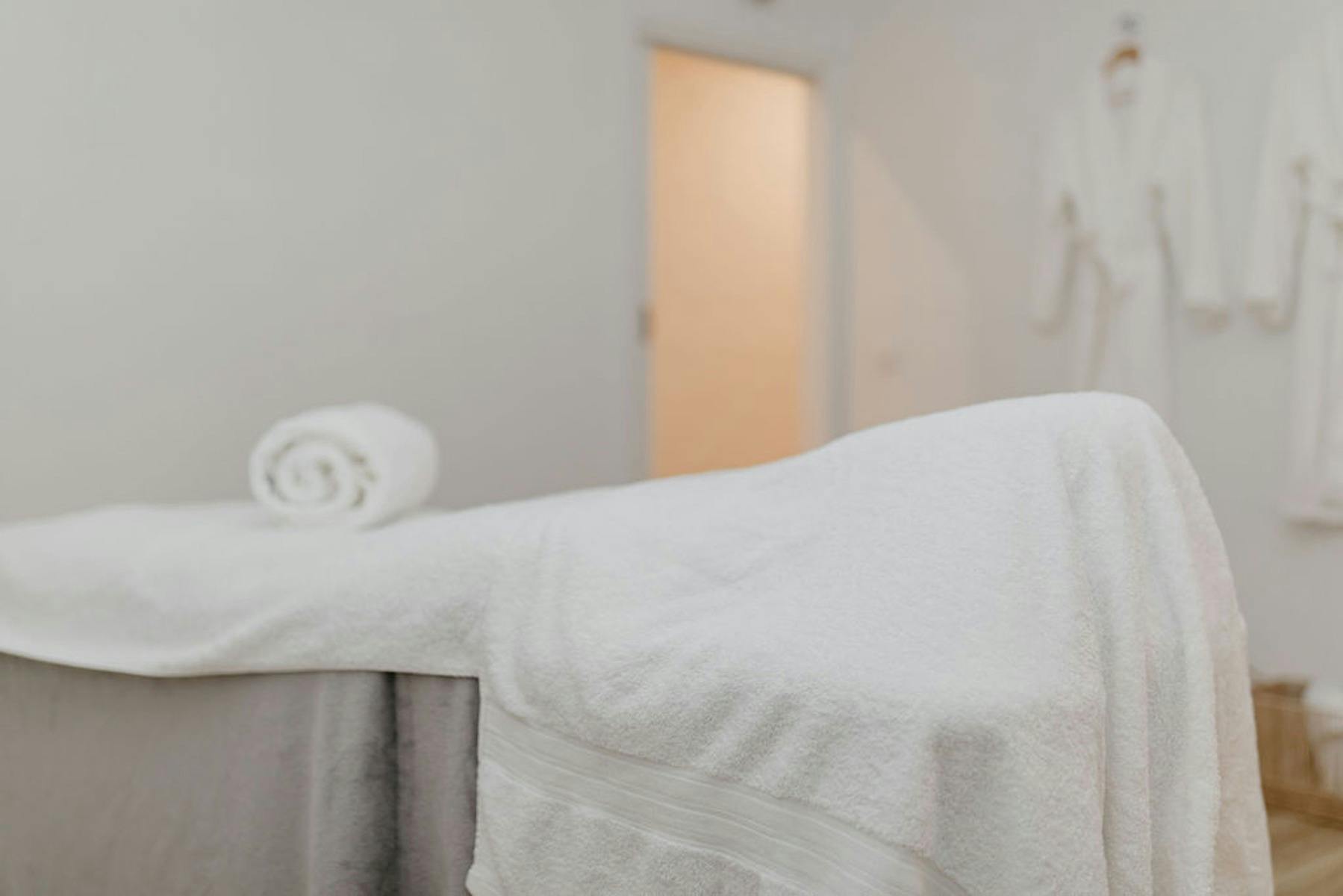 Massage table and robes on the wall