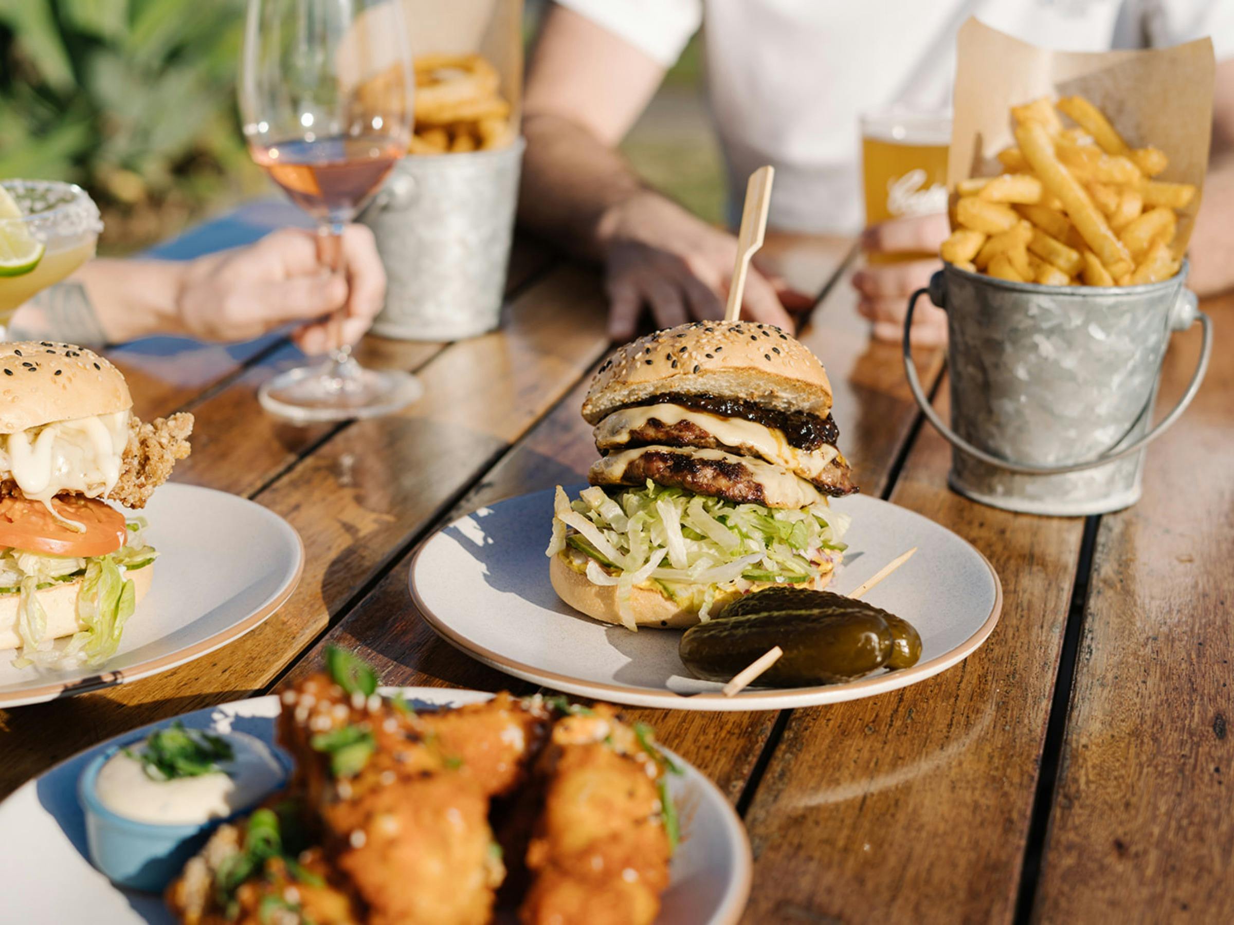 burger, sides and fries on table