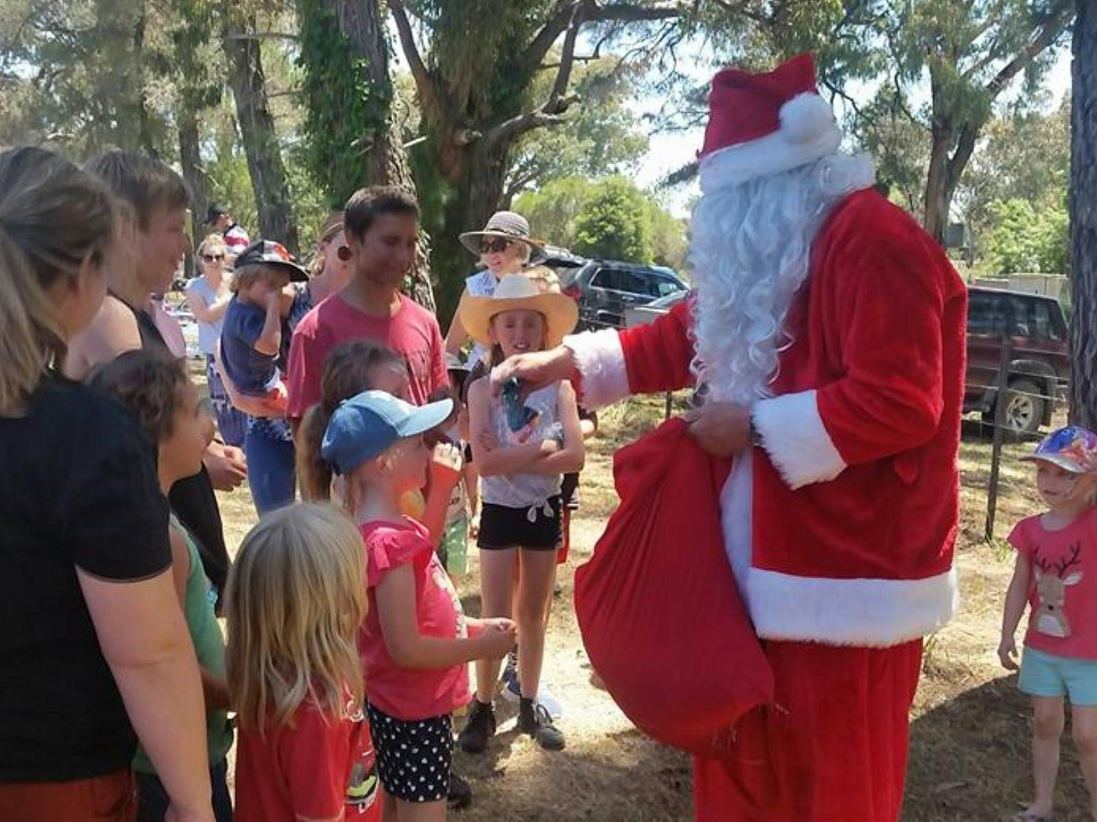 Santa handing out goodies to kids