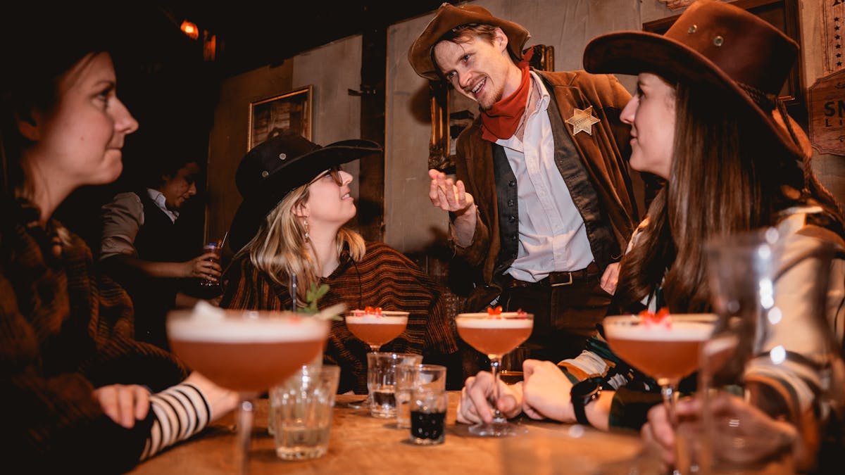 Friends dressed in western-style clothing enjoying drinks together