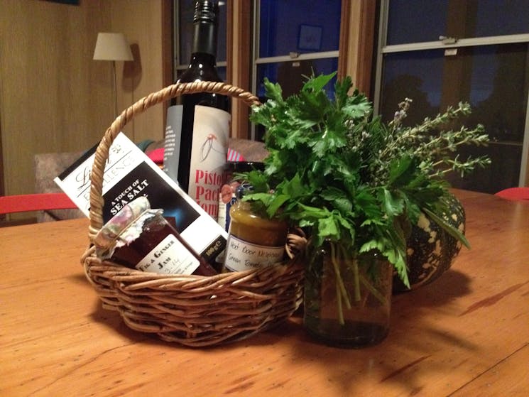 Herbs from garden and basket of local goodies