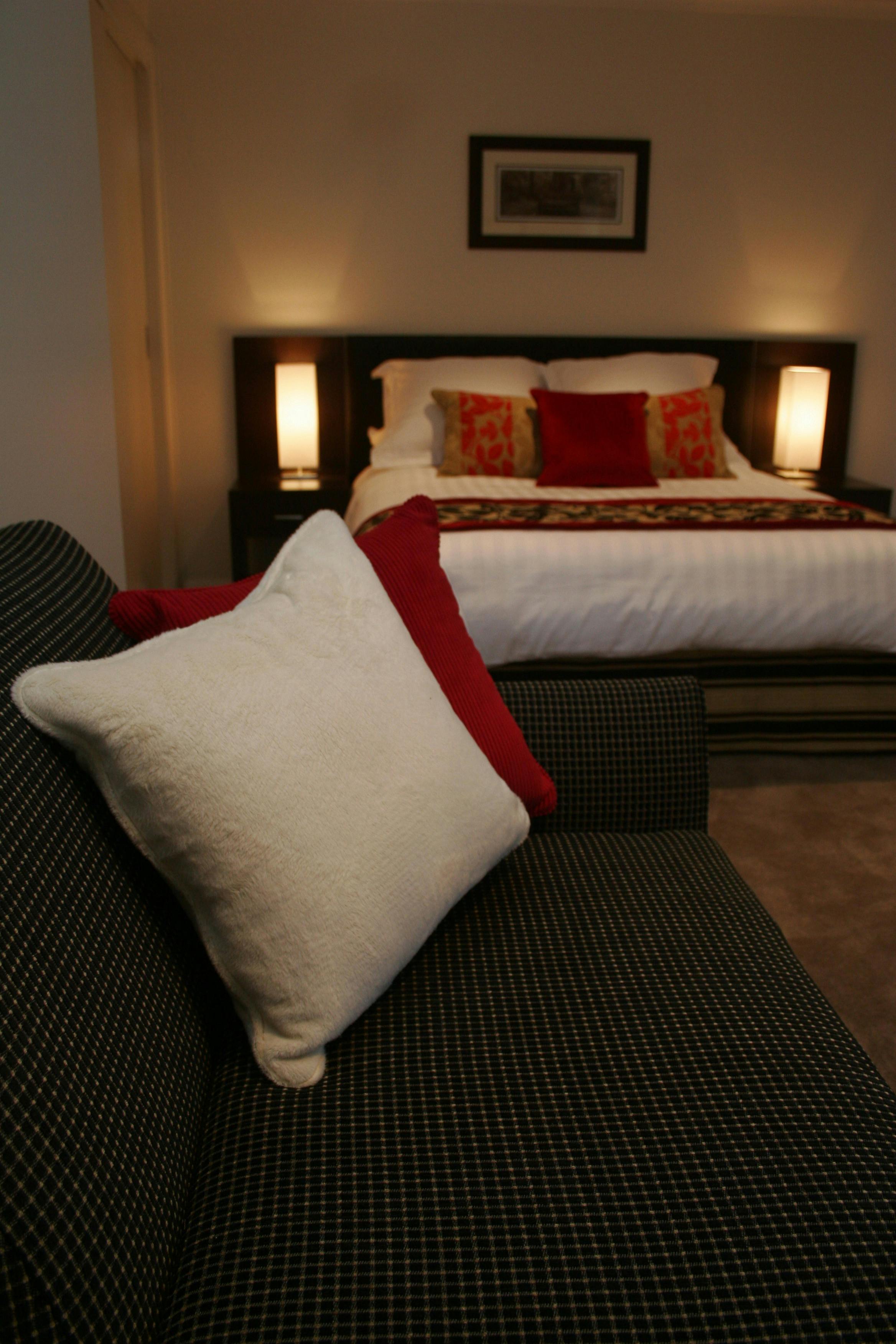 White and red cushions, queen bed, red decor