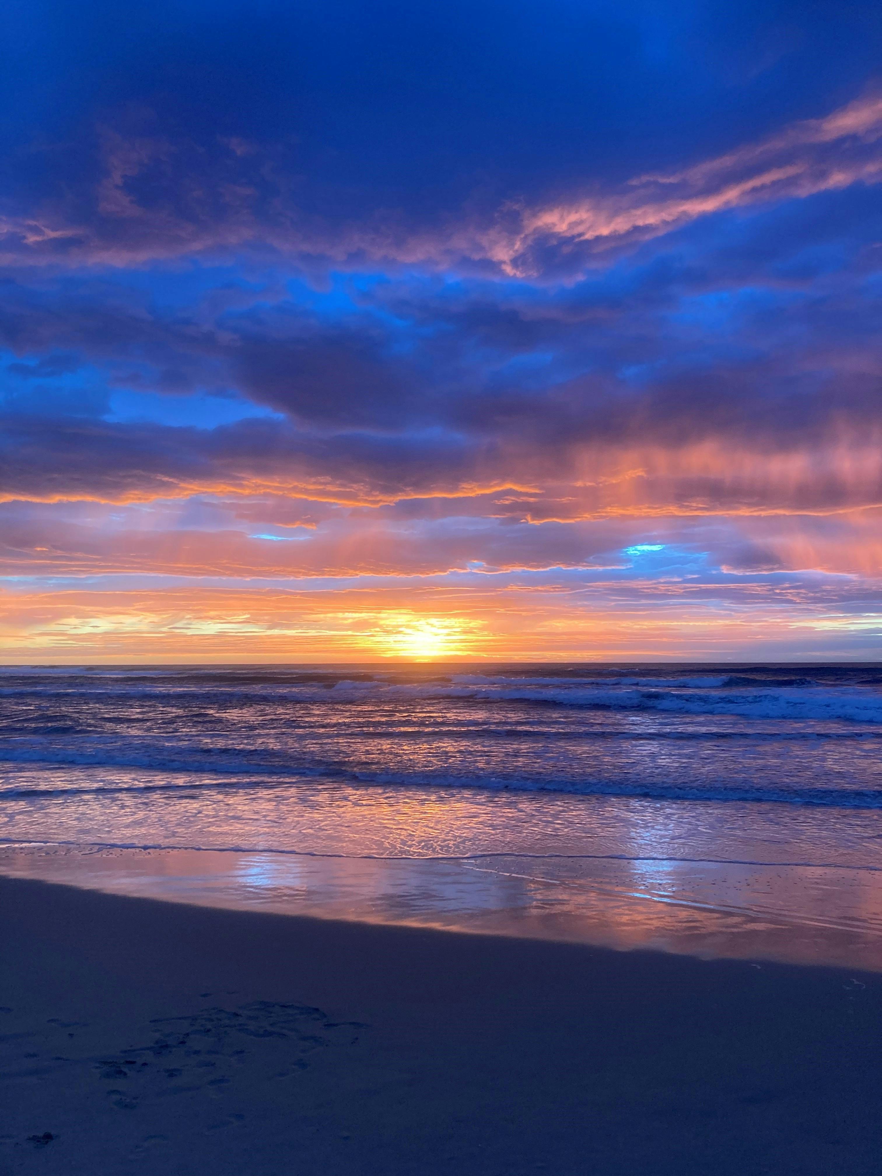 Soft purple morning hues lighting up the sky over our beach practice location.