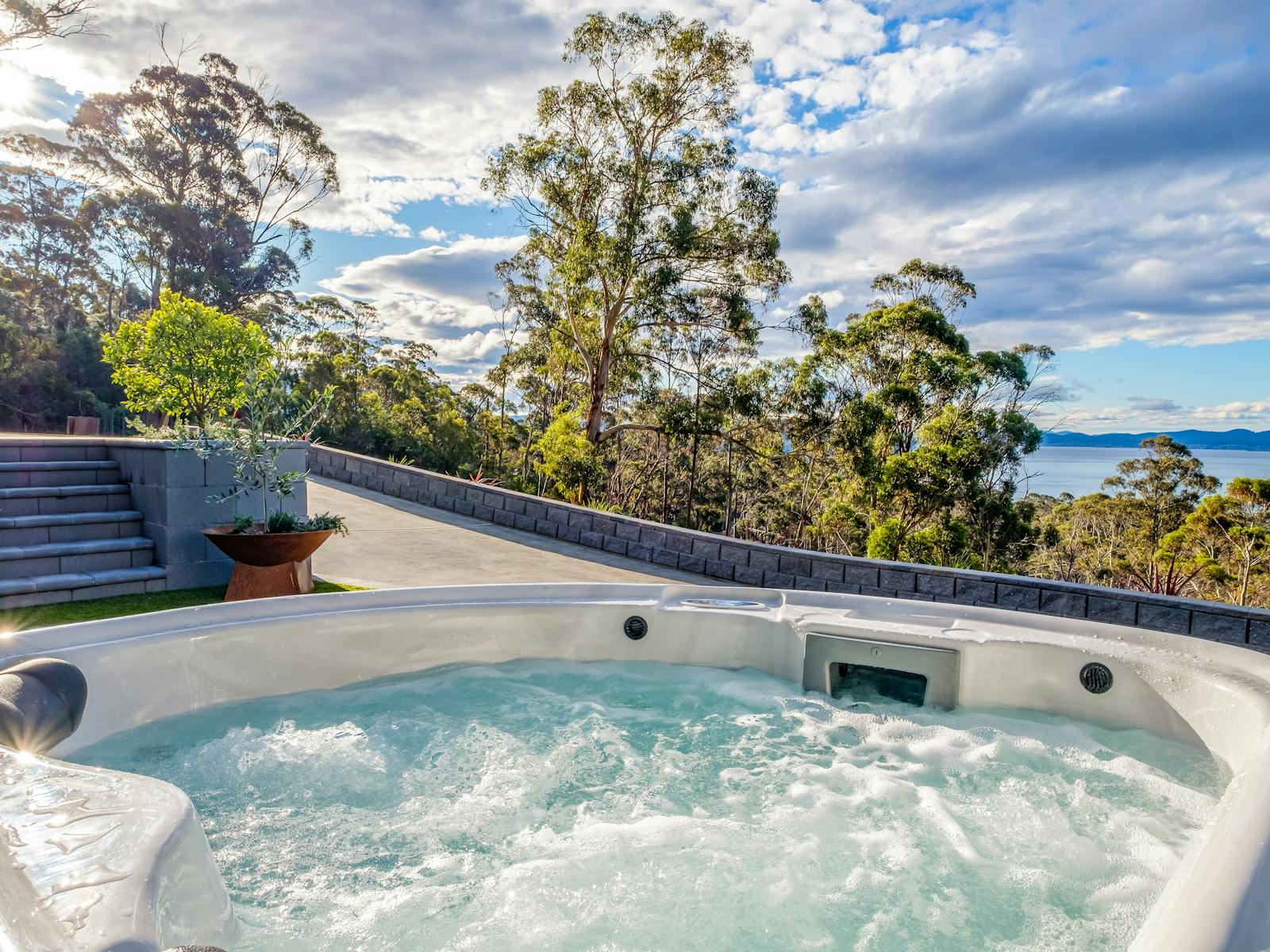 Sink into the hot tub overlooking the water