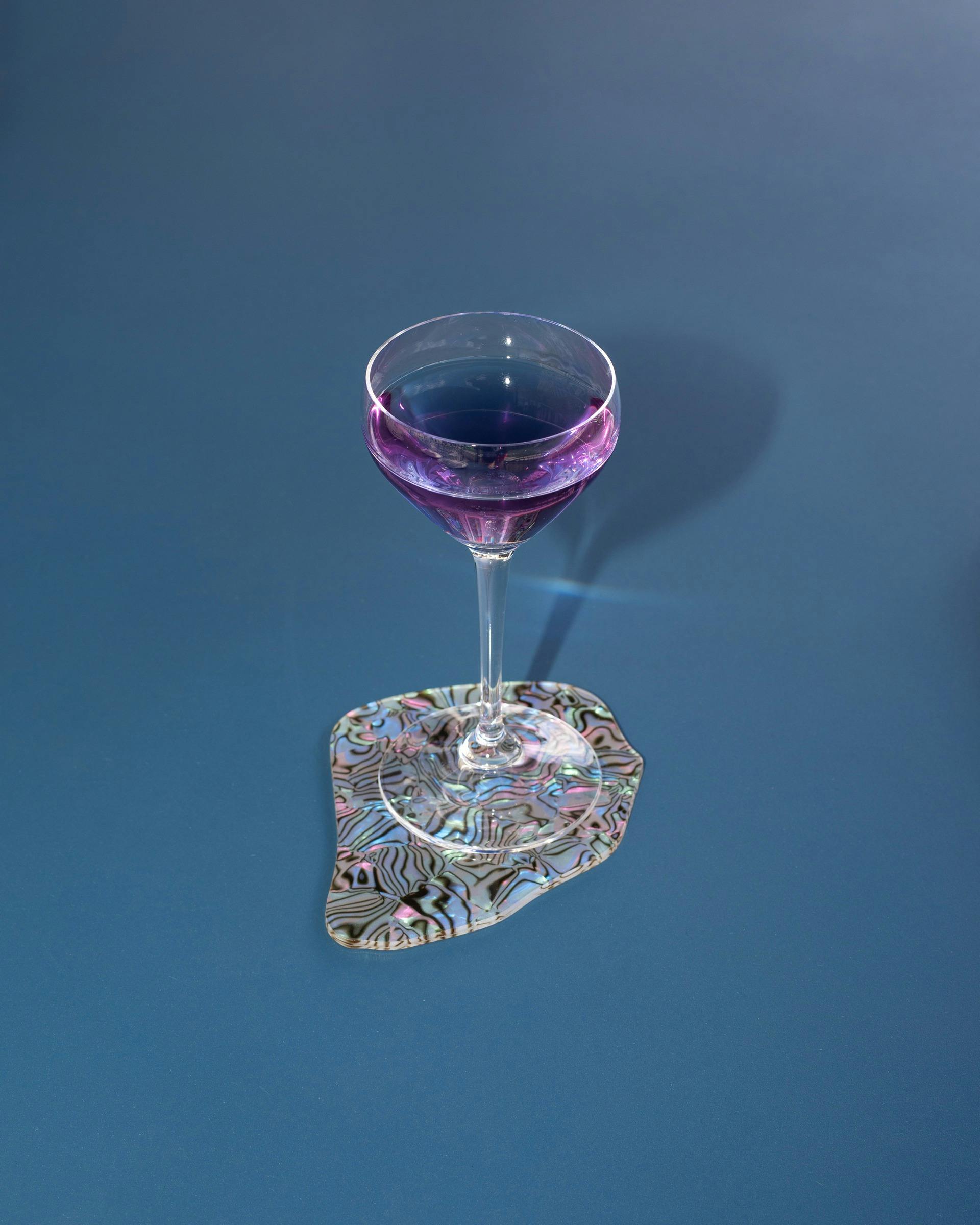 purple cocktial on blue table