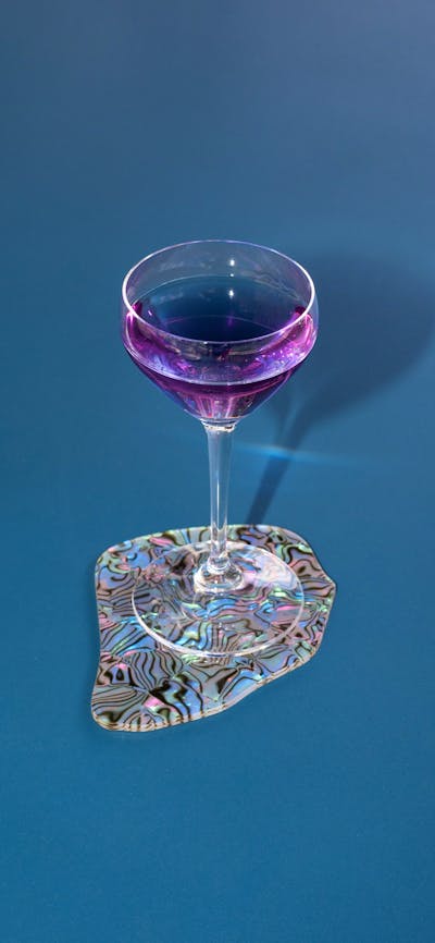 purple cocktial on blue table