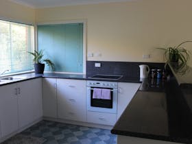 Kitchen with oven, benches and sink