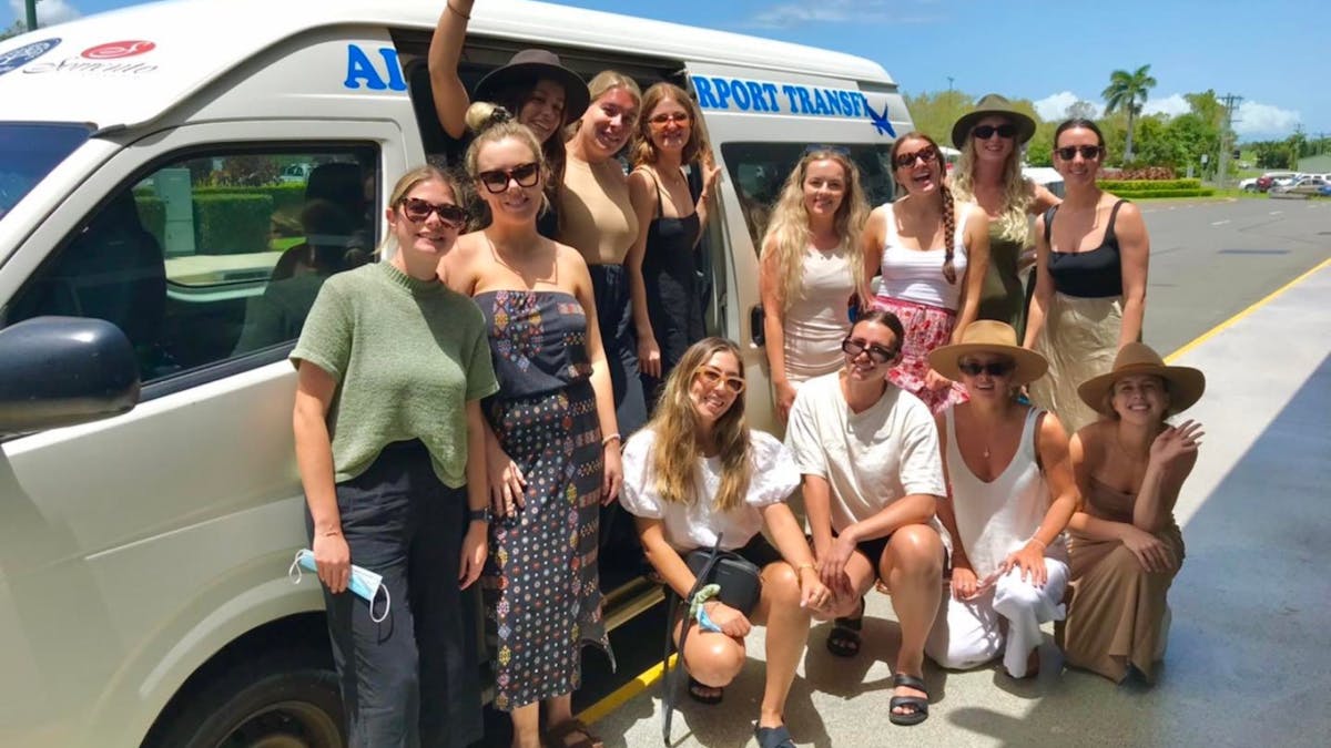 Group of women getting picked up at the airport on a heat of reef shuttles bus