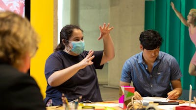 A person in a mask making art