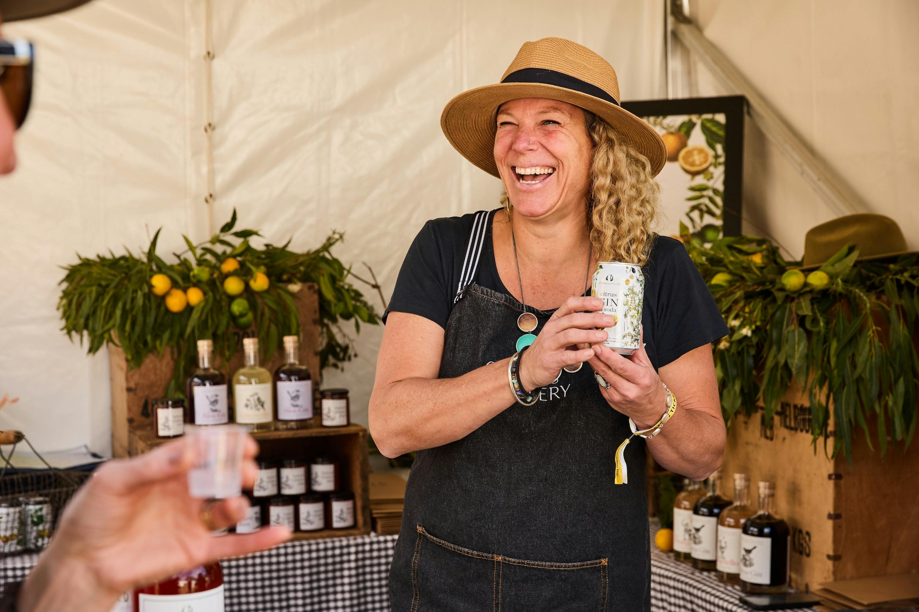 Lady holding a can of gin from Otways Distillery at Grampians Grape Escape
