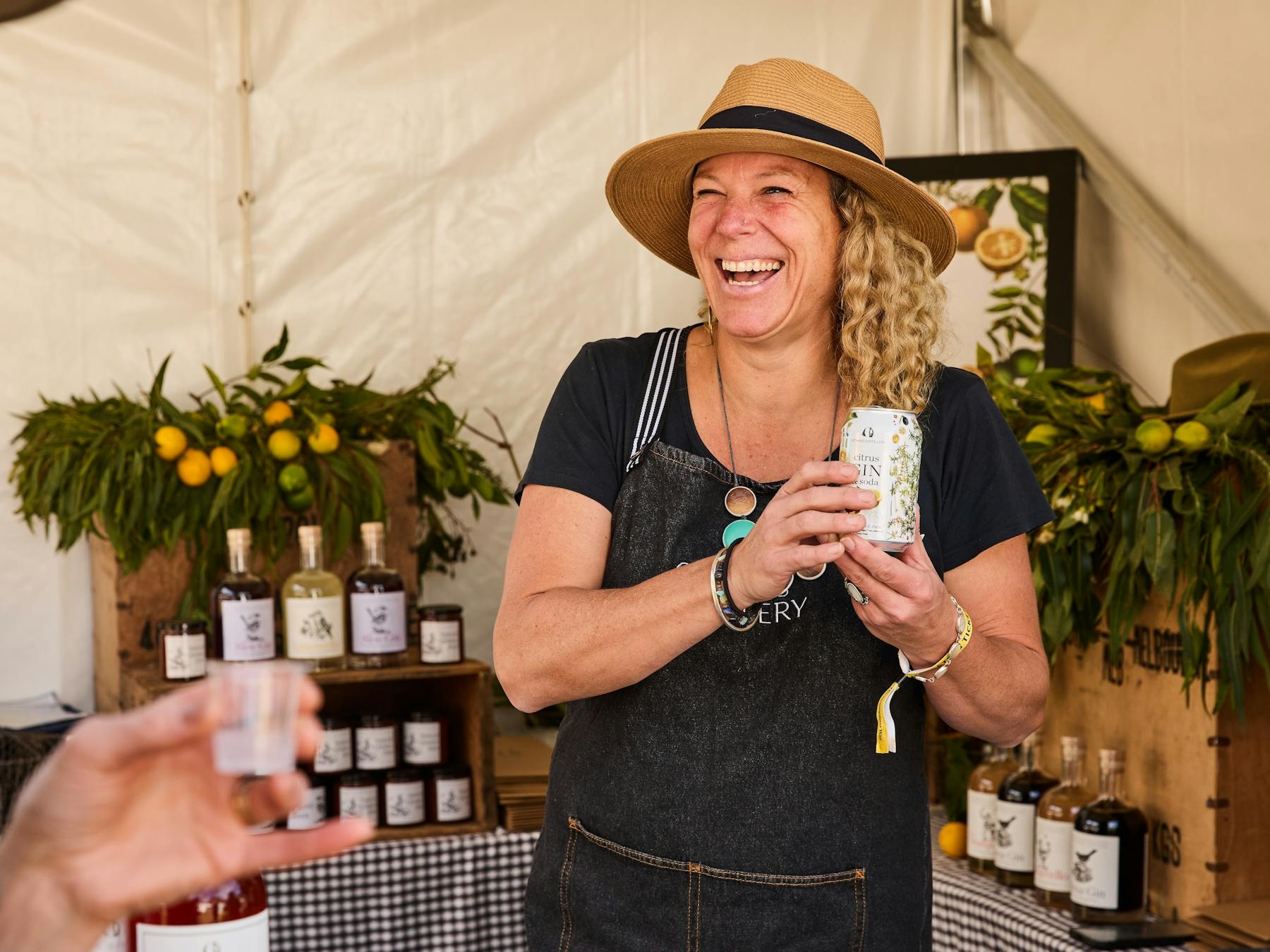 Lady holding a can of gin from Otways Distillery at Grampians Grape Escape