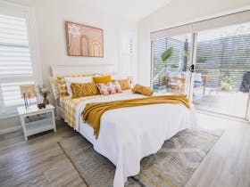 Bedroom with white bedspread and yellow sheets