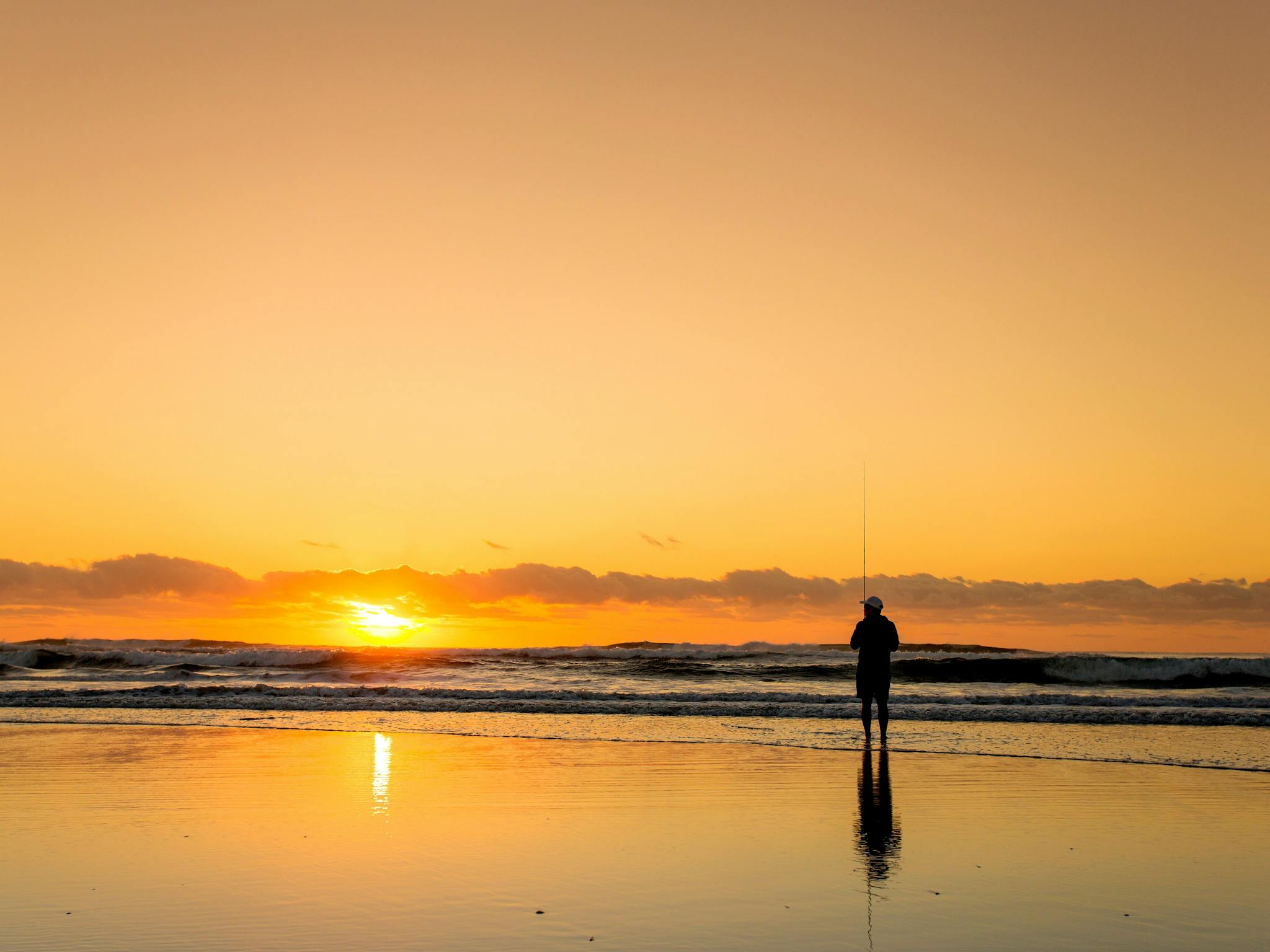 Man fishing on beach in Ballina