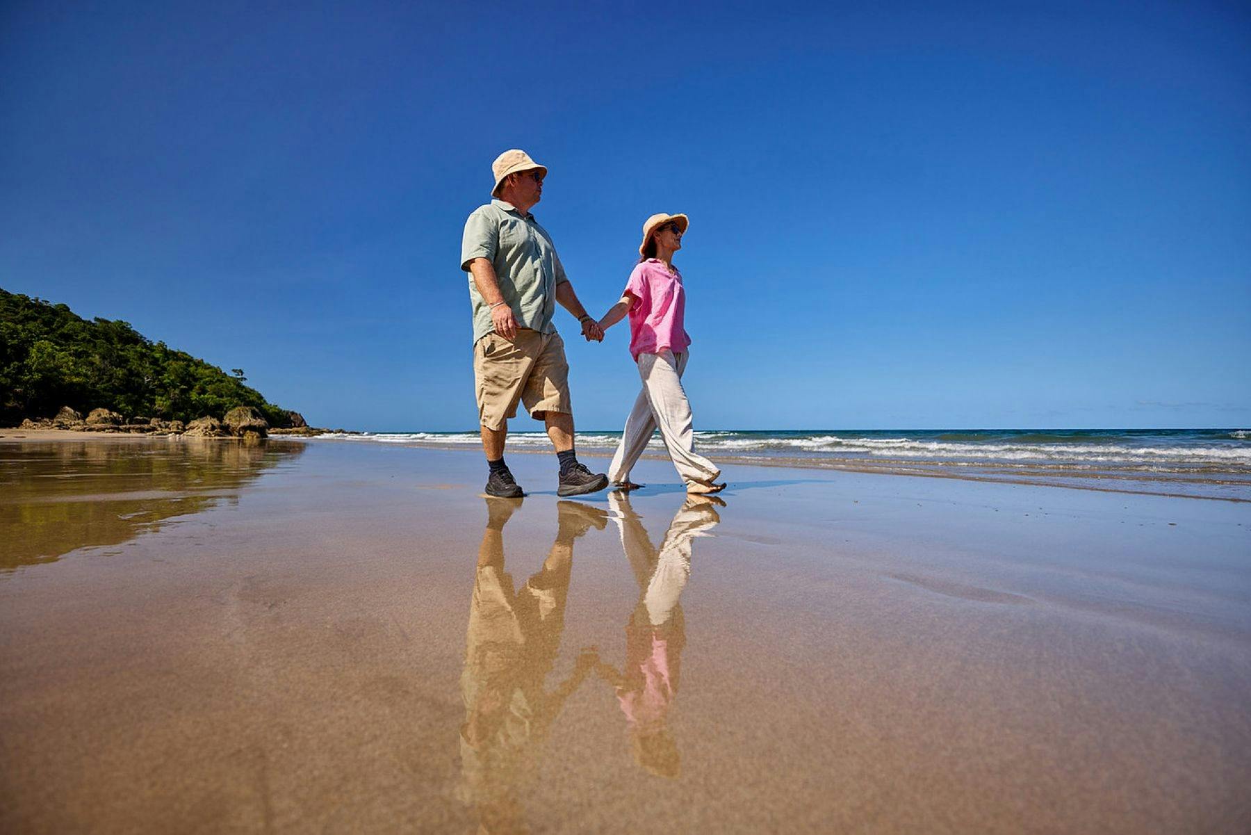 Guests enjoy a beach walk on the stunning waters edge of Etty Bay