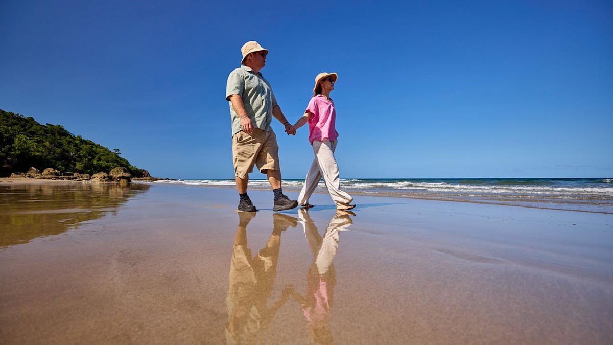 Guests enjoy a beach walk on the stunning waters edge of Etty Bay