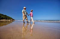 Guests enjoy a beach walk on the stunning waters edge of Etty Bay