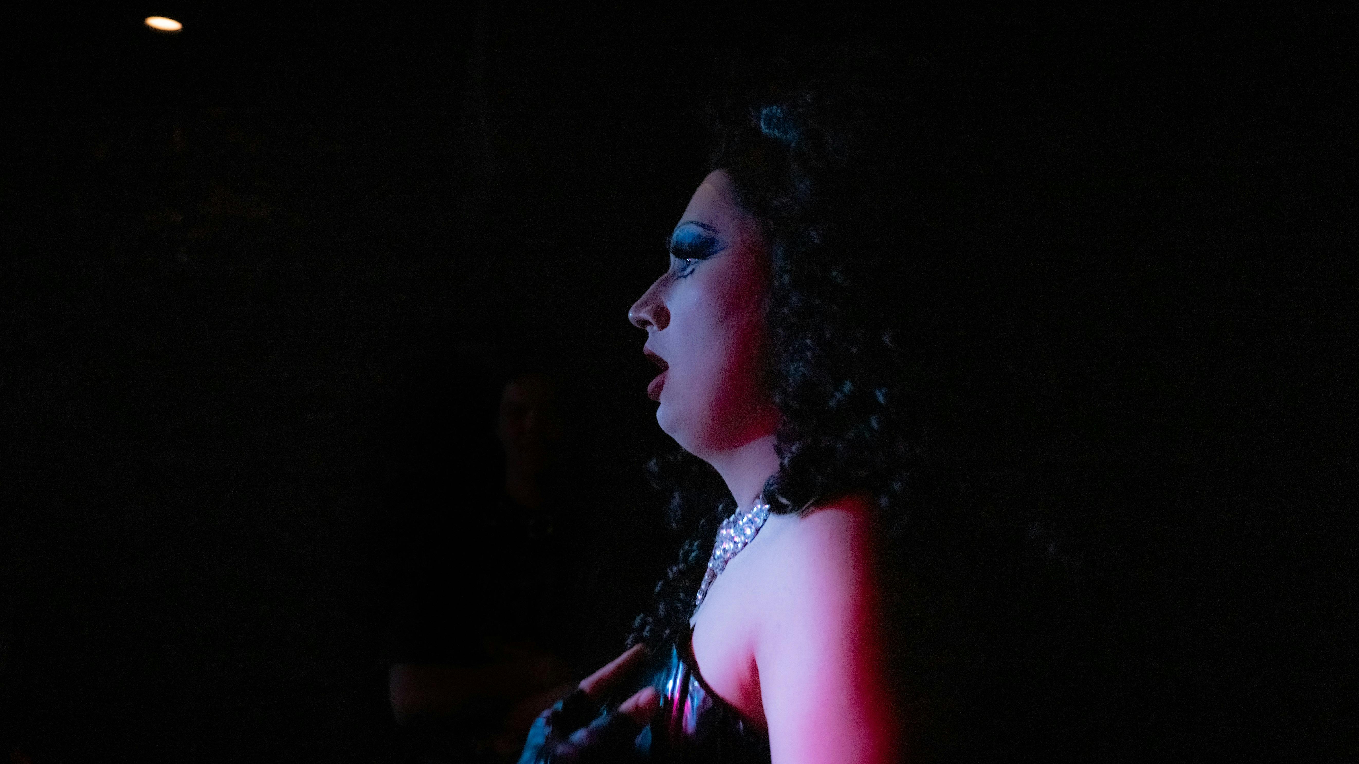 A drag queen performs in profile