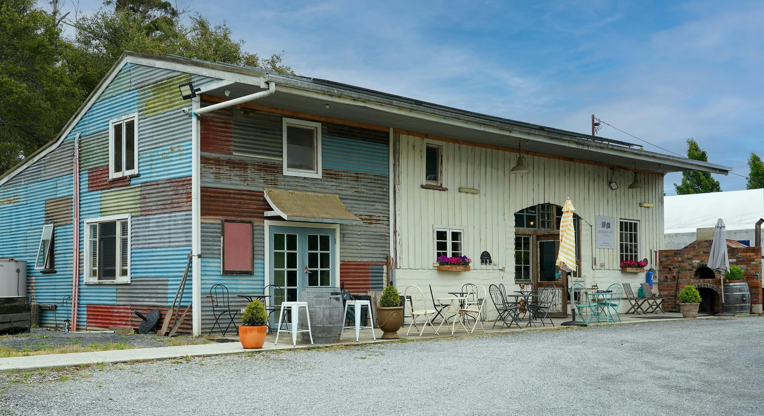 rustic cellar door external covered with multi coloured corrugated iron panels