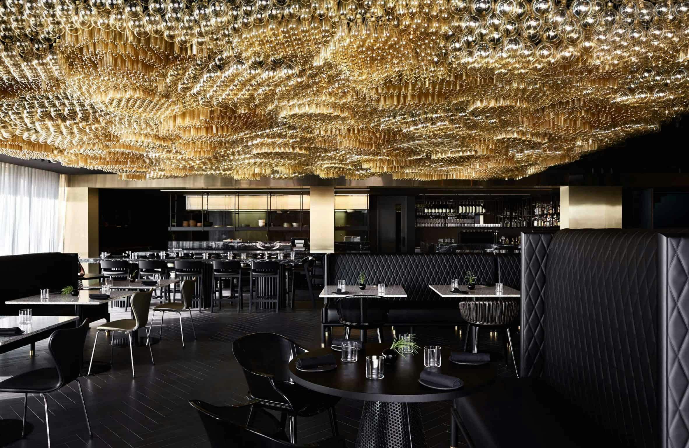 Dining room of restaurant with ceiling filled with light bulbs
