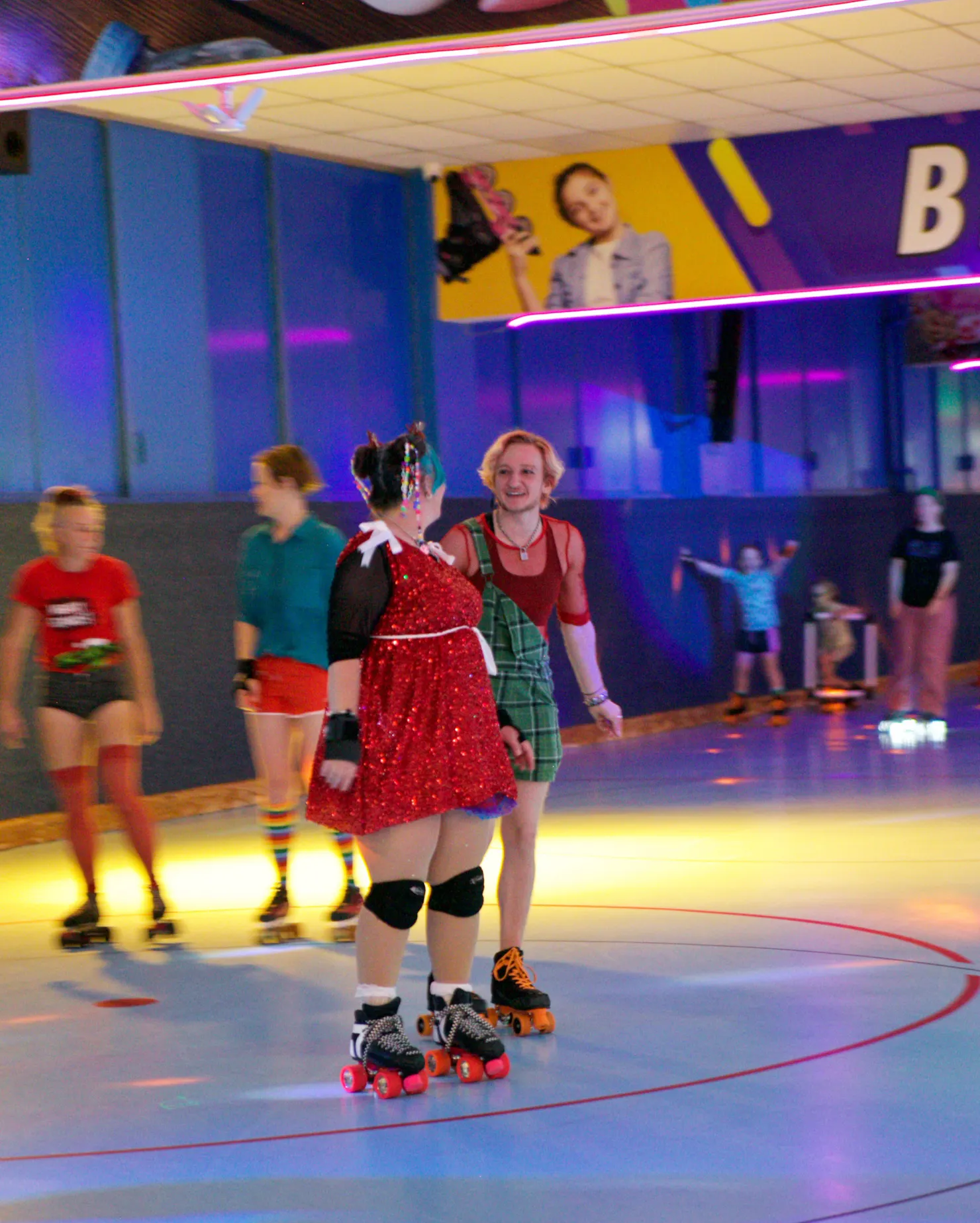 People in the foreground and background chatting while rollerskating