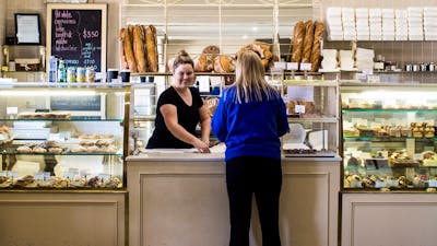 Lady being served at the bakery counter