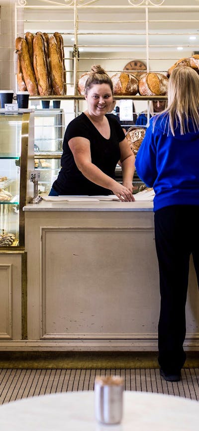 Lady being served at the bakery counter