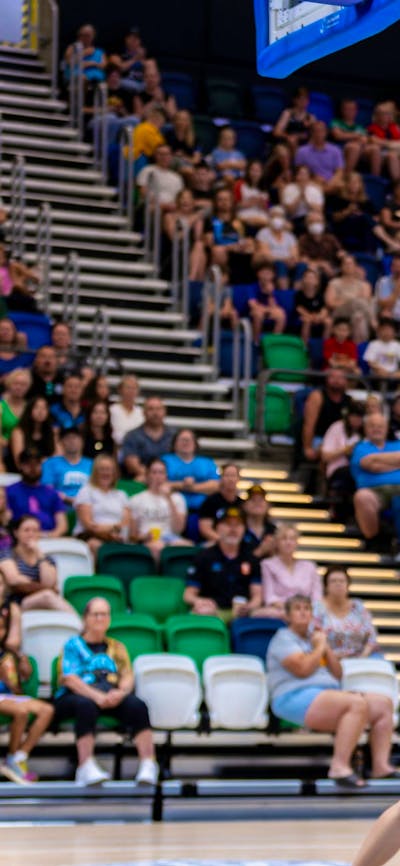 UC Capitals player driving to the basket for a layup during a WNBL game against Sydney Flames.