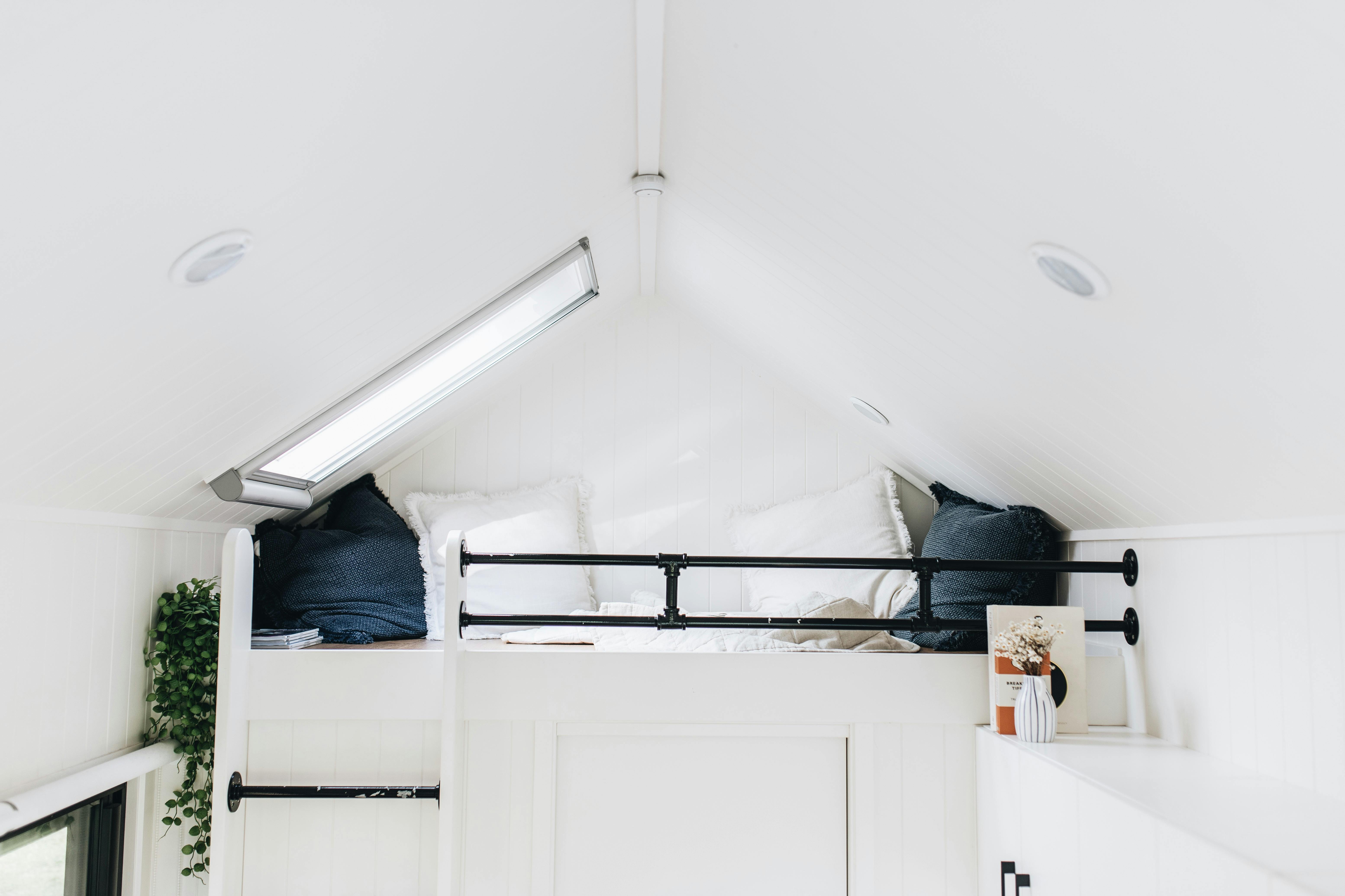 Loft area with cushions and a skylight