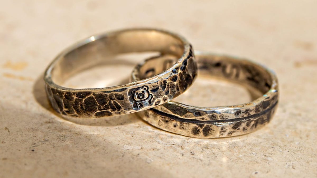 Two rings with hammered designs, highlighting the textured finish left after polishing.