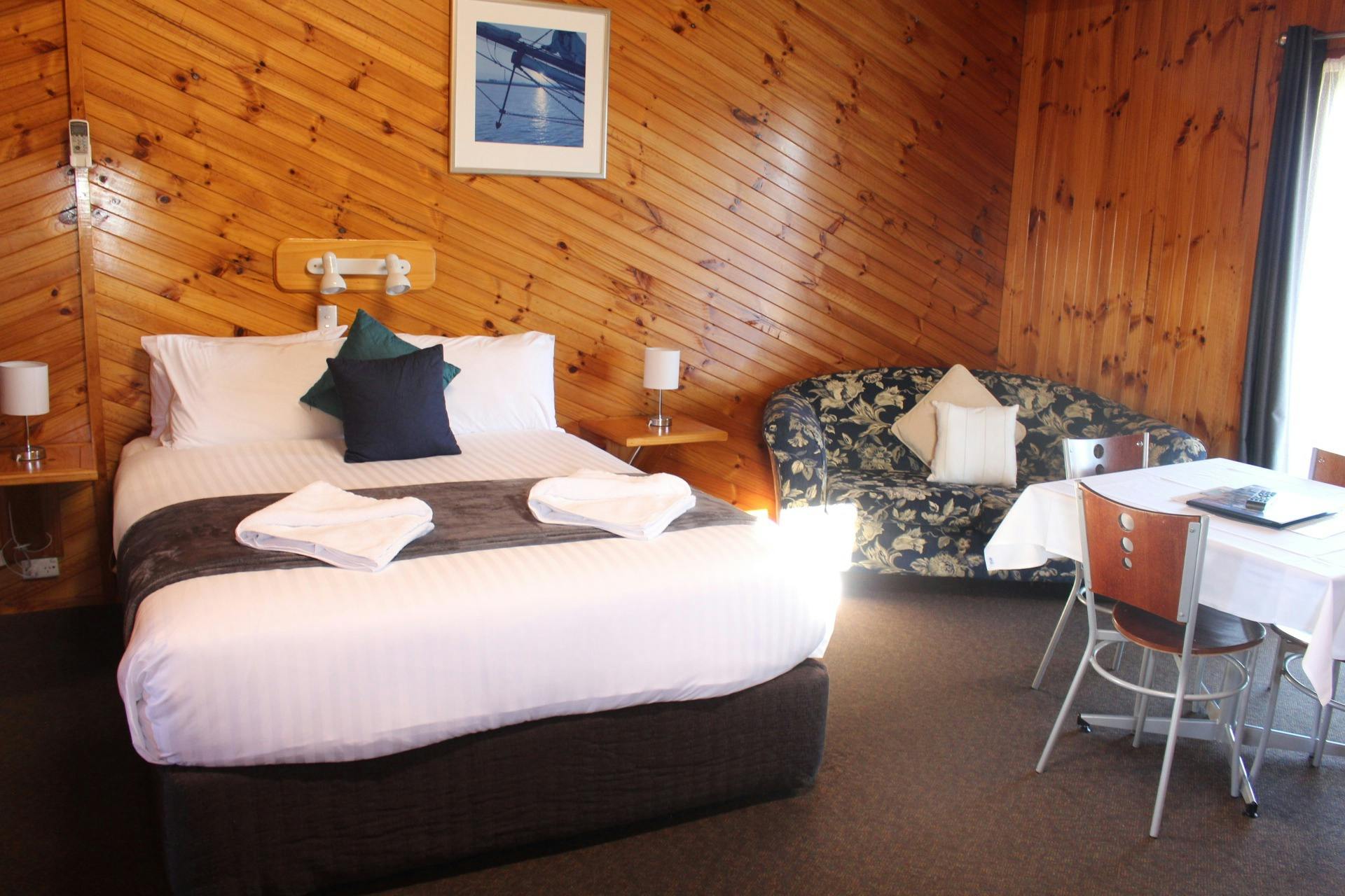 Main queen bed with lounge and dining room table.