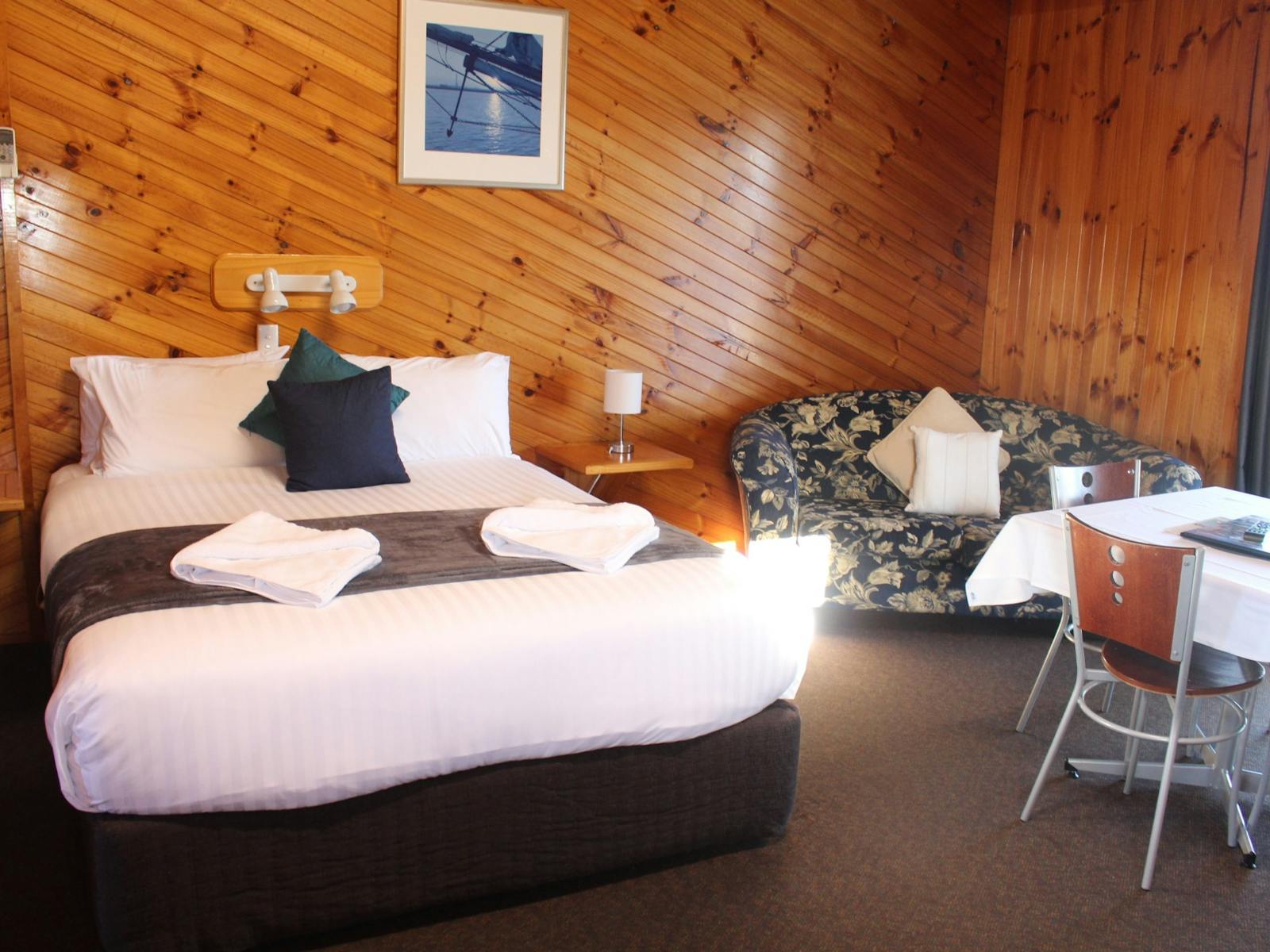 Main queen bed with lounge and dining room table.
