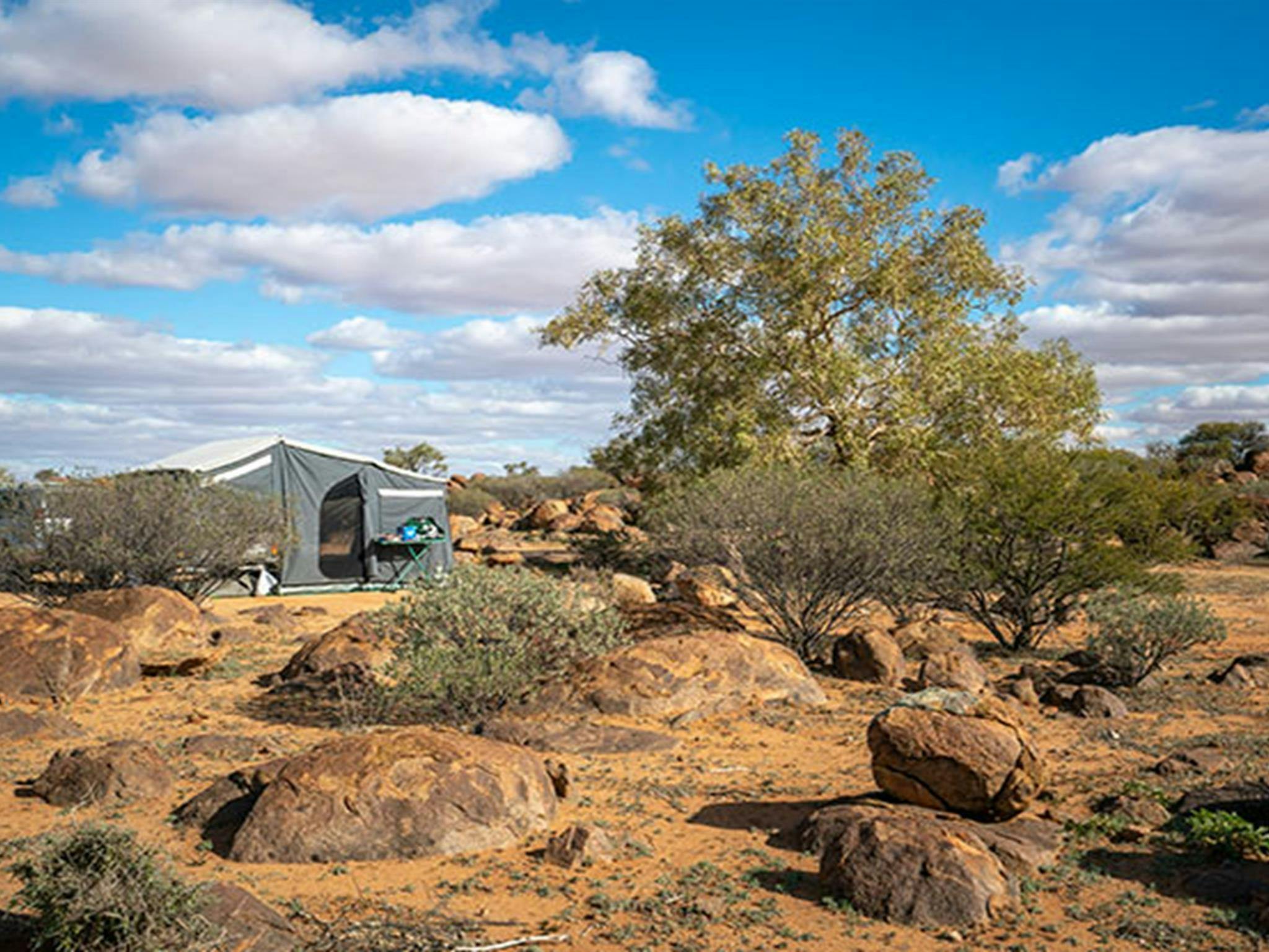 Wohnwagen und Felsbrocken auf dem Campingplatz Dead Horse Gully im Sturt-Nationalpark. Foto: John