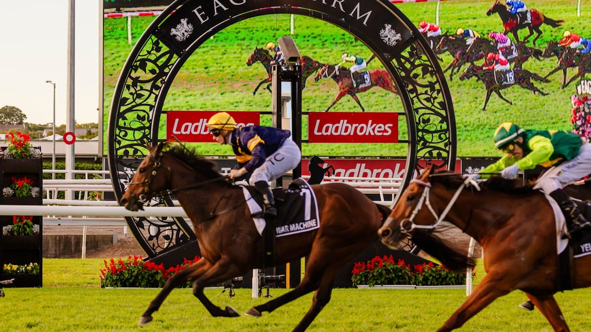 A horse running past the Eagle Farm winning post