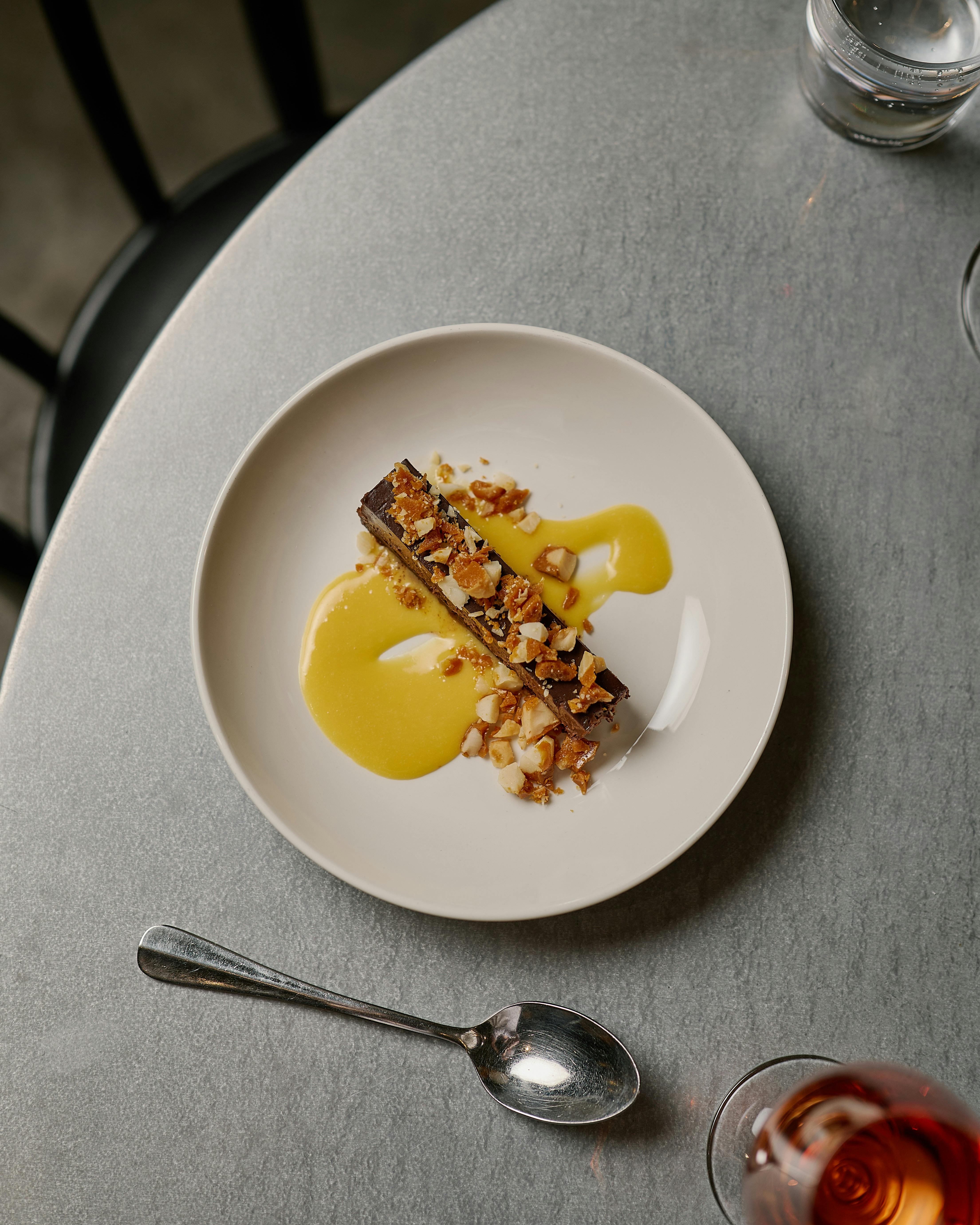 Chocolate Pave, passionfruit curd, roast macadamias