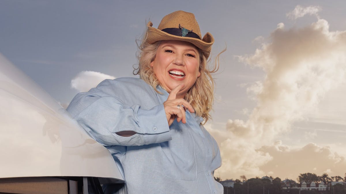 Urzila Carlson is pictured on a yacht smiling wearing a blue shirt and a brown hat Urzila Carlson is pictured on a yacht smiling wearing a blue shirt and a brown hat