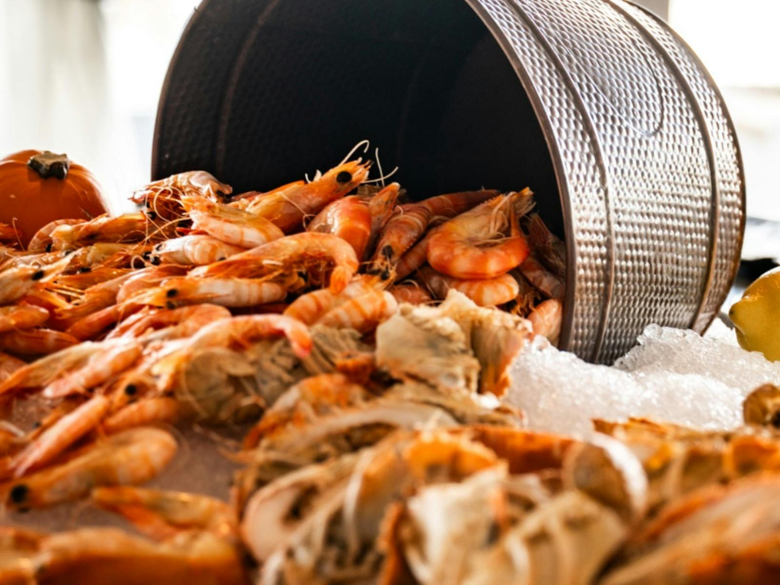 Fresh cooked prawns presented as part of a seafood buffet.