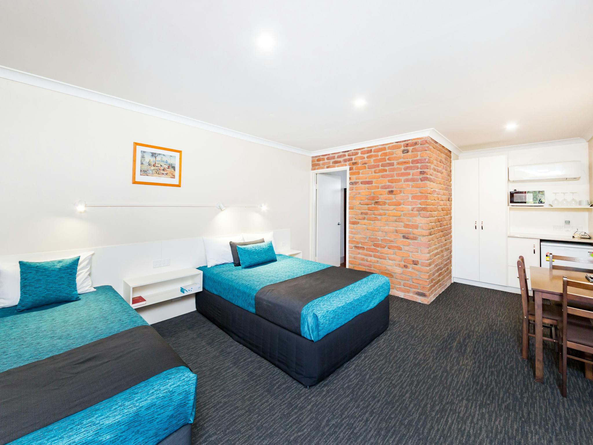 Spacious air-conditioned room with a comfortable Queen bed & Single bed, lounge, table & chairs Spacious air-conditioned room with a comfortable Queen bed & Single bed, lounge, table & chairs