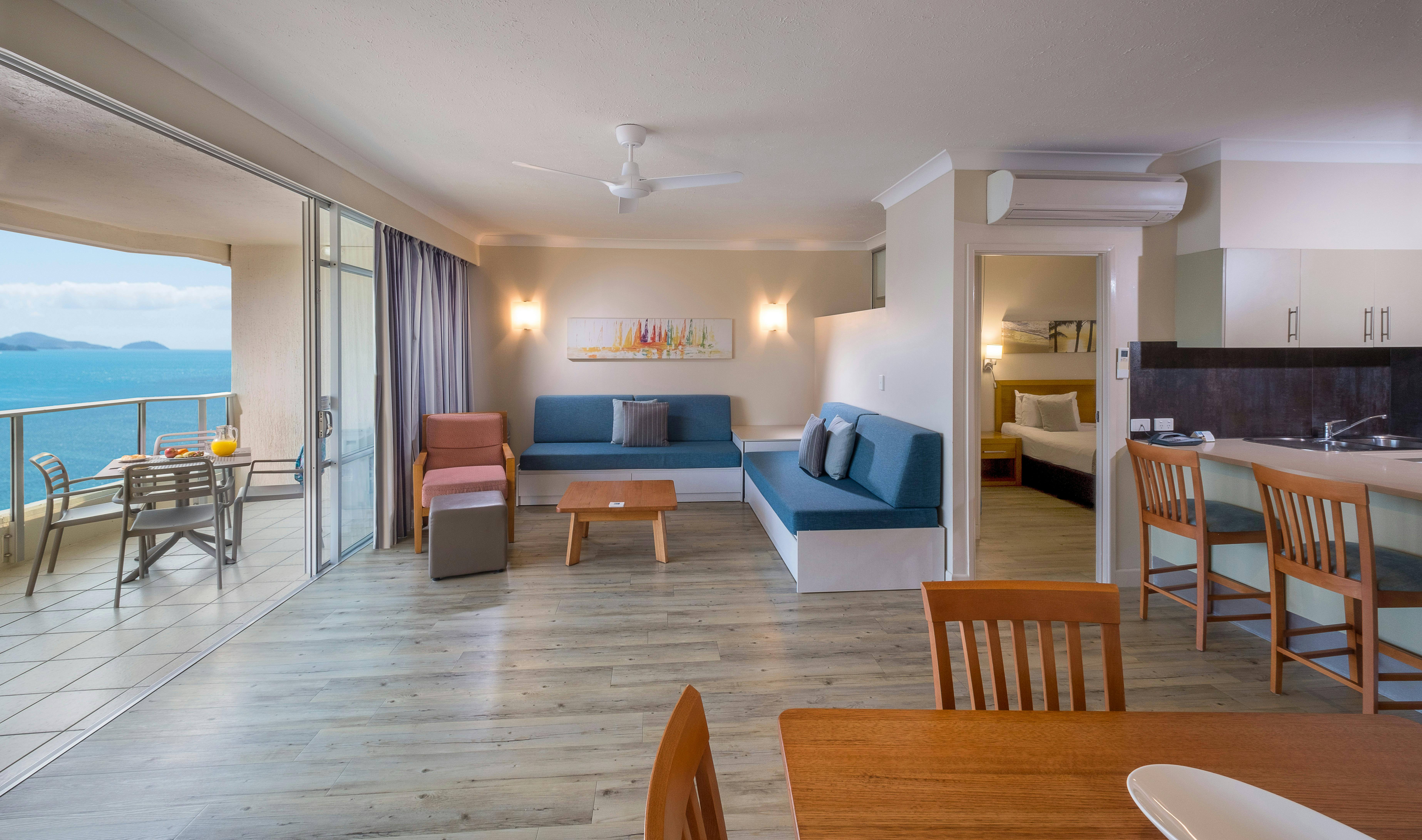 Apartment dining and living area with balcony view of Catseye Beach