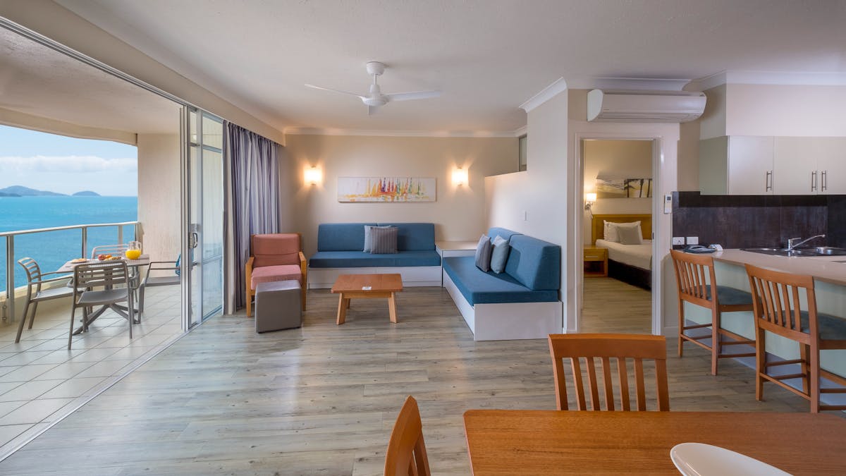 Apartment dining and living area with balcony view of Catseye Beach