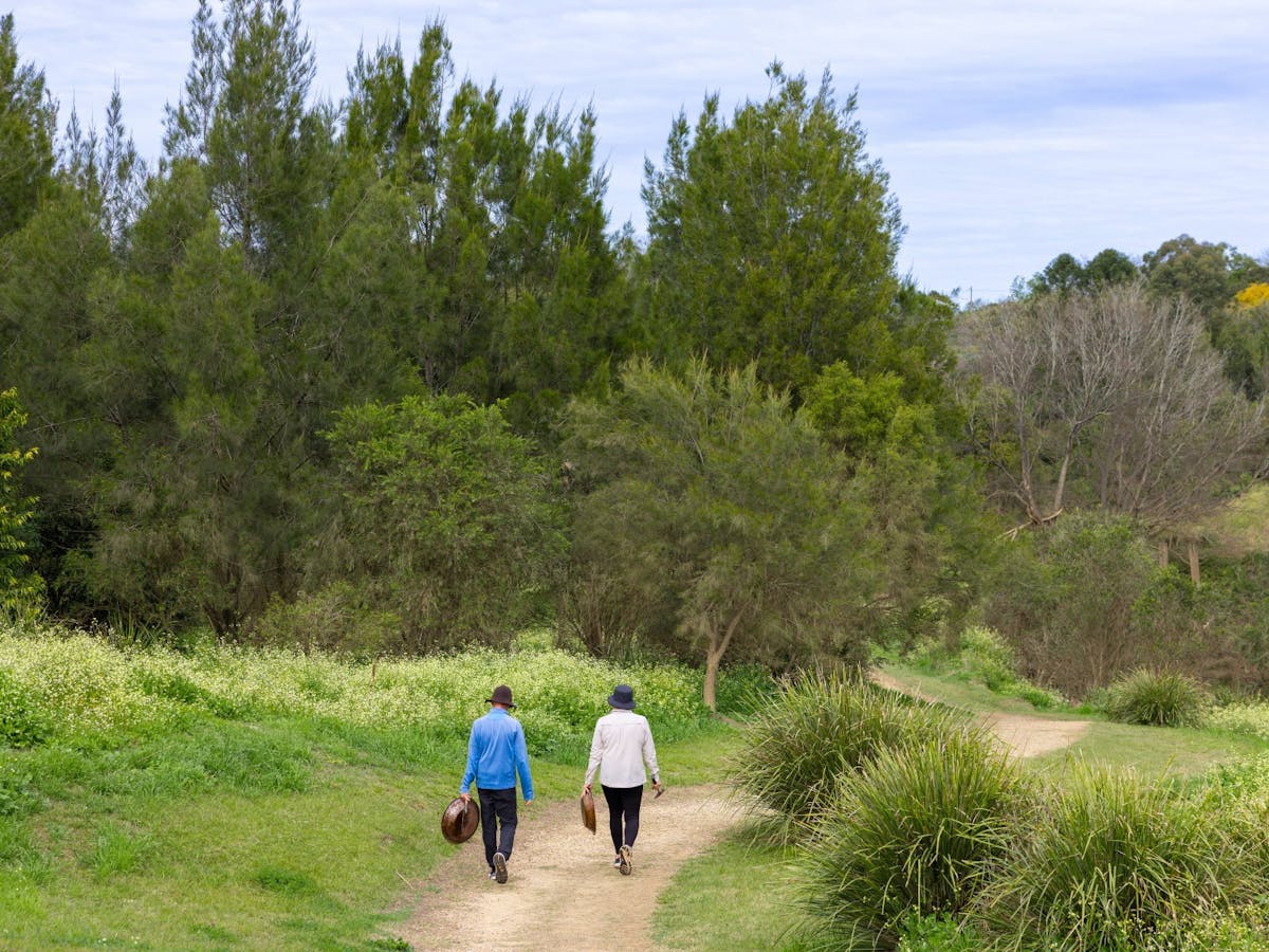 A couple walking down to the creek to start fossicking