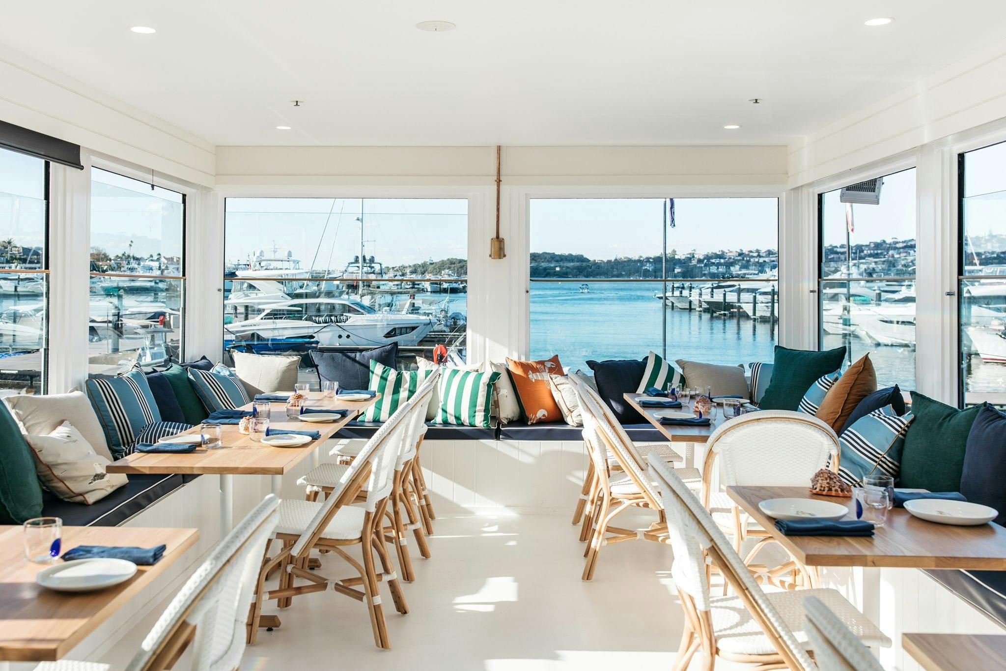 Bright marina restaurant interior with harbour views for EV Arcadia Electric Indulgence