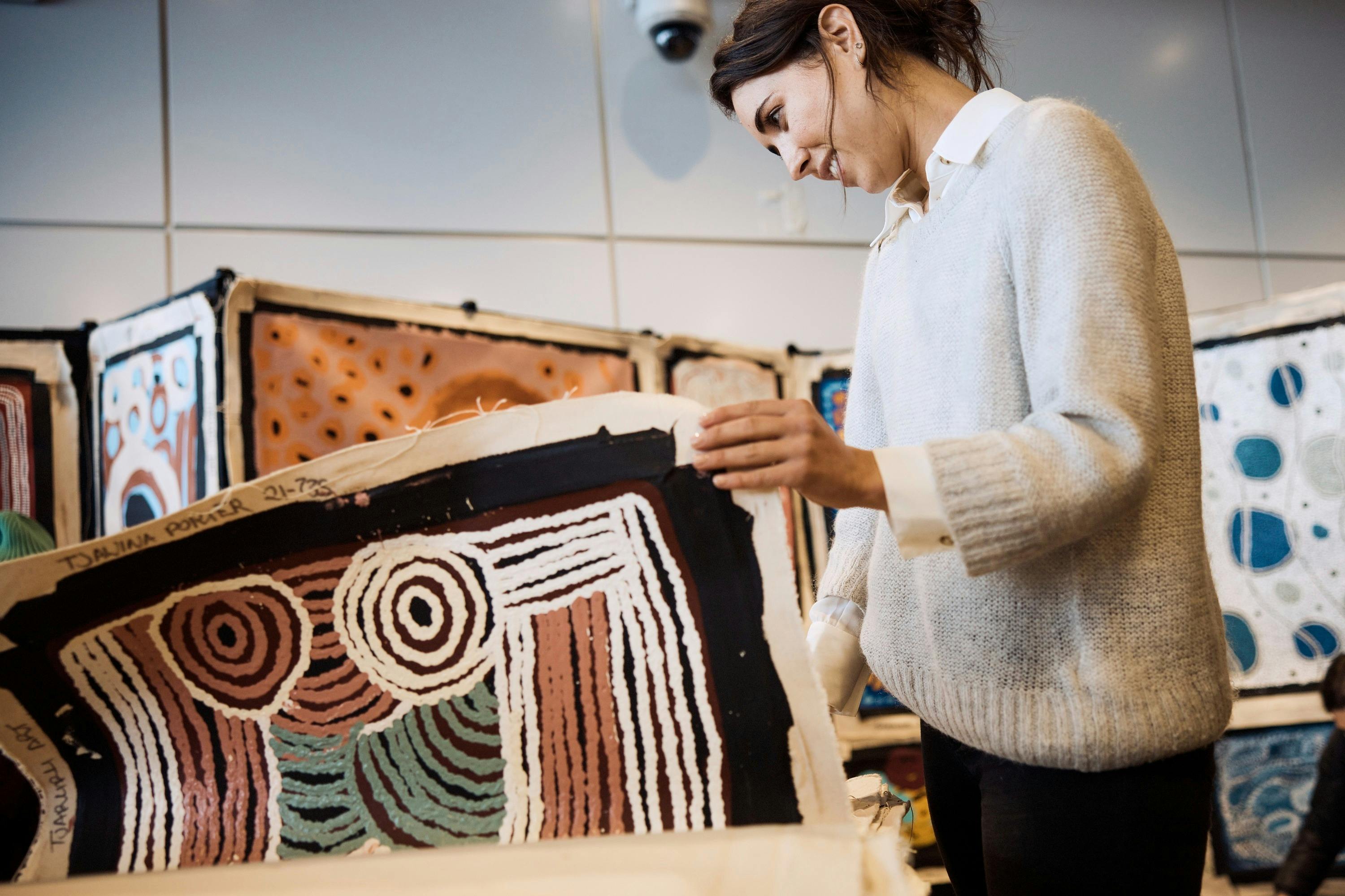 Woman exploring Aboriginal art in The Rocks.