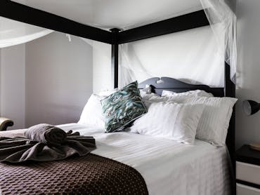 4 poster bed with white linen and maroon and teal bedding 4 poster bed with white linen and maroon and teal bedding