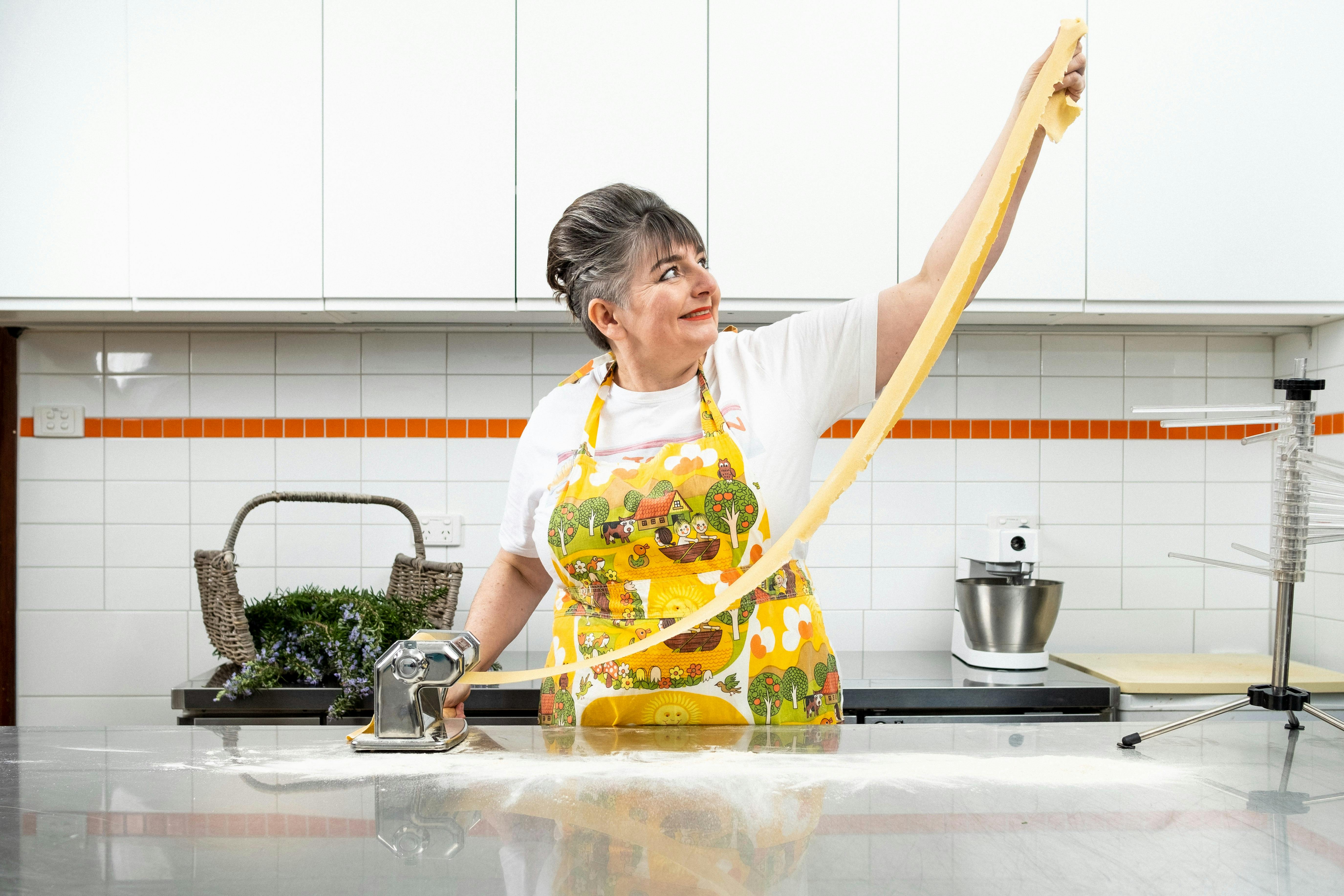 Women in a ktichen rolling pasta